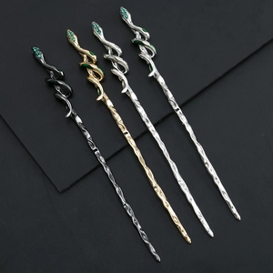 Detail of snake hairpins with green crystals and enamel in gold and silver finishes