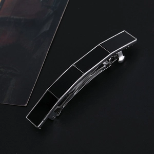 Detail of elegant black acrylic panels on a minimalist silver geometric spring hair clip