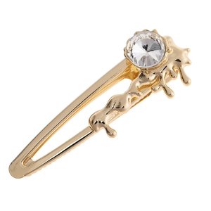 Pince à cheveux en métal doré avec un grand cristal rond dans un style minimaliste pur