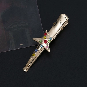 Golden star hair clip with colorful rhinestones and polished metal duckbill design