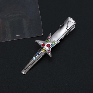 Detailed close-up of a silver star hair clip with colorful crystals and metal finish