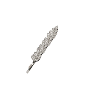 Macro detail of leaf-shaped hair clip with shimmering rhinestones and silver finish