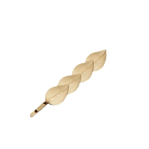Detailed view of golden metal hair clip featuring four layered leaves with intricate veins