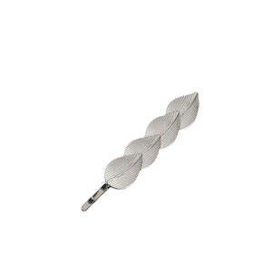Detailed view of silver leaf hair clip with realistic vein textures on white background