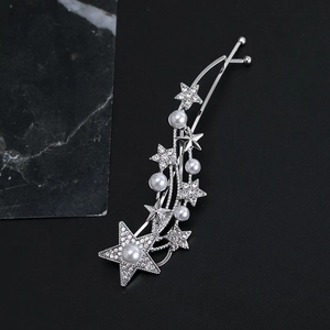 Close-up of shooting star hair clip with glittering rhinestones and elegant white pearls