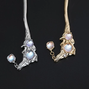 Detailed close-up of retro alloy hair sticks with moonstone and branch texture