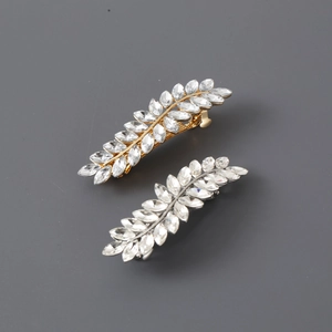 Elegant gold and silver leaf hair clips set with sparkling marquise crystal stones