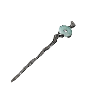 Close-up of irregular wave metal hair stick with green jadeite centerpiece in retro style