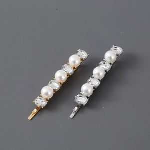 Elegant gold and silver hair clips with pearls and rhinestones in linear arrangement