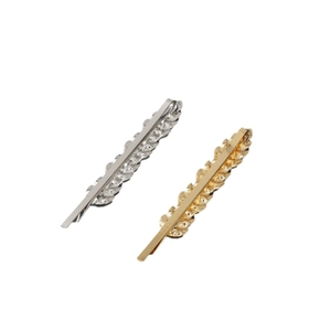 Minimalist leaf texture hair clip set in gold and silver metal finishes on white background