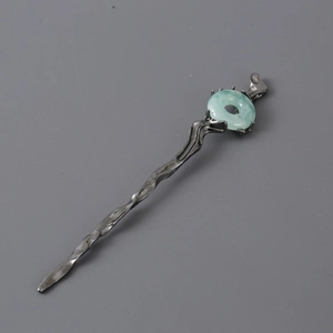 Vintage irregular dark metal hair pin featuring a pale green jade stone insert