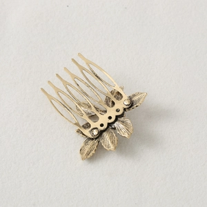 Vintage gold leaf hair comb with six metal teeth featuring artistic layered leaf patterns