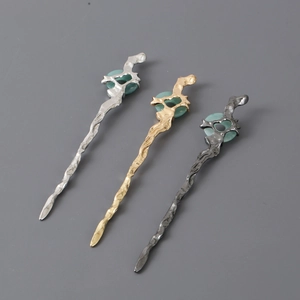 Detail of irregular wave-textured hair pins with green jade-style rings in three colors