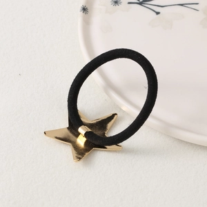 Minimalist black elastic hair tie with a golden star charm on a clean white background