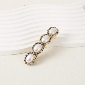 Elegant vintage hair clip with four faux pearls in gold woven metal frames for women