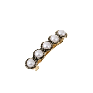 Vintage gold metal spring hair clip with five white pearls and black beaded edge details