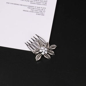 Vintage silver leaf hair comb with pearl center and detailed metallic textures