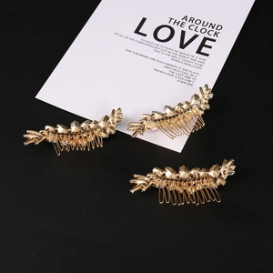 Three-piece set of golden leaf hair combs with textured wheat ear design on black background