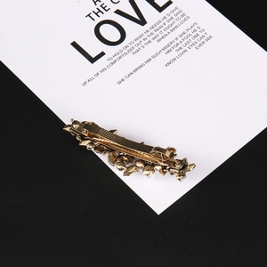 Elegant gold metal flower hair clip with pearl accents and non-slip spring clamp