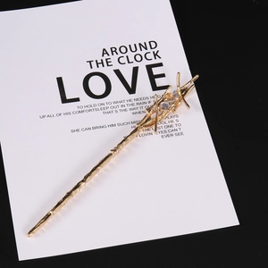 Detail of Harry Potter magic wand hair pin with gold branch texture and moonstones