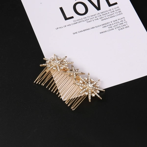 Detailed macro view of gold-tone hair comb featuring sparkling rhinestone stars