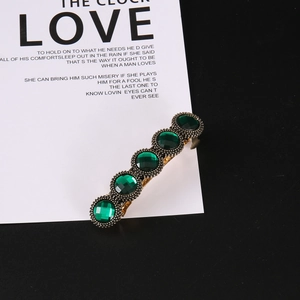Vintage gold hair clip with five emerald green gemstones for elegant hair styling