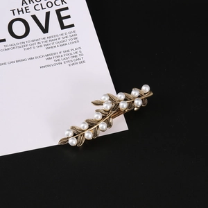 Elegant gold leaf hair claw with white pearls, vintage style minimalist accessory for women