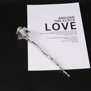 Detailed view of vintage silver rose hair pin with pearl accent and textured metal stem