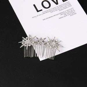 Macro detail of silver moon and star hair comb with sparkling rhinestones and metal teeth