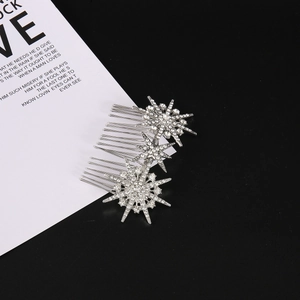 Detail of silver star-shaped hair comb with tassels and sparkling rhinestone accents