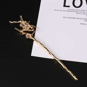 Detailed view of the gold-plated irregular hair pin with inlaid opal stones and textured finish