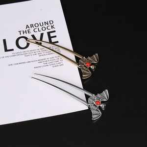 Detail of gothic punk bat hairpins with red beads in bronze and silver finishes