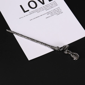 Detail of dark metallic hair pin with hammered texture and vintage irregular spiral design