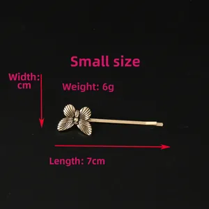 Macro detail of retro gold butterfly hair clip showing 7cm length and alloy texture