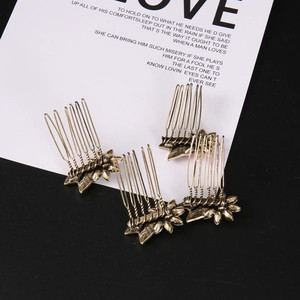 Detailed view of four golden alloy flower hair combs with vintage floral and leaf patterns