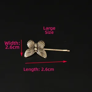 Detailed close-up of butterfly hair clip showing intricate wing texture in bronze finish