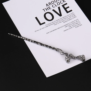 Detailed view of handmade hammered texture on vintage silver metal hairpin with wavy design