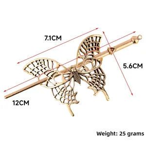 Detail of vintage bronze butterfly hair pin with intricate hollowed filigree design