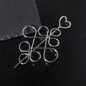 Polished silver metal hair stick with hollow Chinese knot design and heart detail