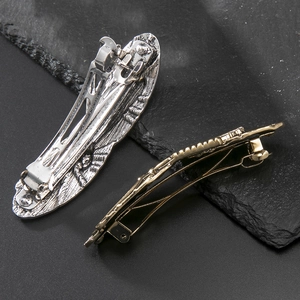Vintage dragonfly hair clips in silver and gold tones with detailed metal textures