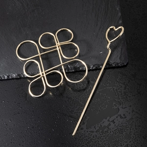 Golden hollow Chinese knot hair slide and heart hairpin set with a polished finish