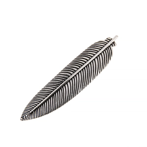 Vintage silver feather hair clip with detailed carvings on a clean white background
