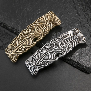 Vintage Celtic style metallic hair clips in bronze and silver with swirl relief textures