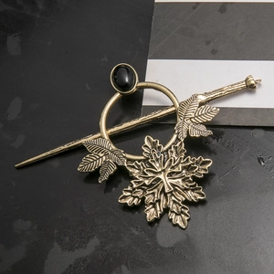 Detail of gothic punk hair pin with maple leaf charms and black gemstone in bronze finish