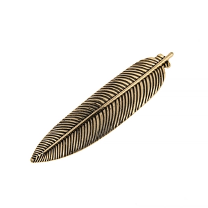Detailed view of antique gold feather hair clip showing intricate texture and metal craftsmanship