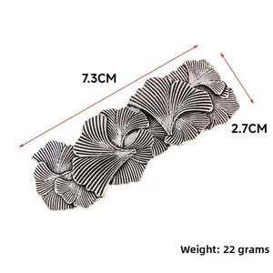 Detail of vintage silver ginkgo leaf hair clip with textured patterns and 7.3cm size
