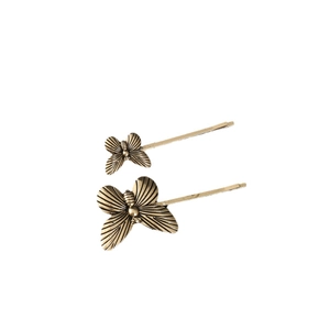 Elegant vintage gold butterfly hair clips set with realistic metallic texture on white background