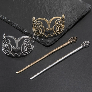Celtic style metal hair pin set in gold and silver finish with intricate hollow knot design