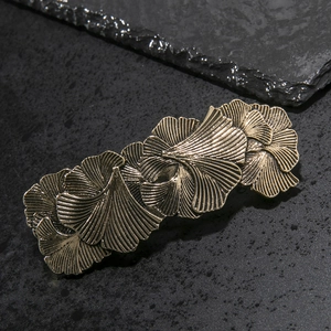 Vintage bronze ginkgo leaf spring hair clip for women featuring detailed metal texture
