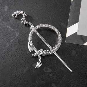 Retro silver dragon hair pin with intricate scale details on black leather texture